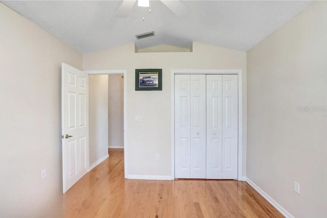 4407 Whitton Way, New Port Richey, FL 34653 - unfurnished bedroom with light wood-type flooring, vaulted ceiling, a closet, and ceiling fan