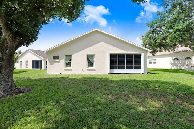 4407 Whitton Way, New Port Richey, FL 34653 - back of house with a lawn and stucco siding