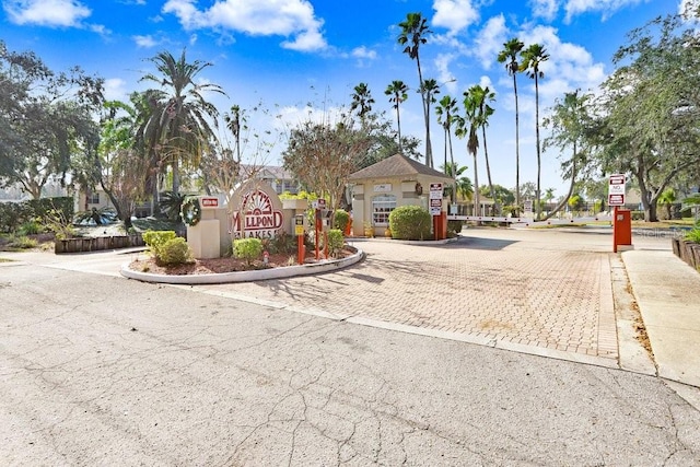 4407 Whitton Way, New Port Richey, FL 34653 - view of street with curbs, traffic signs, and a gated entry