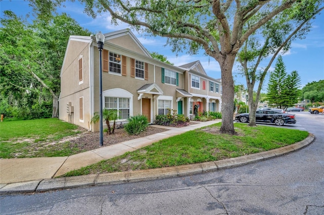 5502 Carrollwood Key Dr, Tampa, FL 33624 - view of property with stucco siding and a front lawn