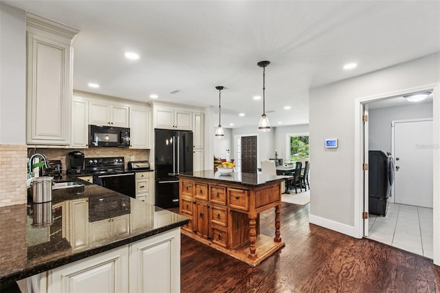126 Holly Tree Ln, Brandon, FL 33511 - kitchen featuring black appliances, decorative backsplash, dark stone countertops, dark wood-type flooring, and recessed lighting