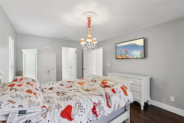 126 Holly Tree Ln, Brandon, FL 33511 - bedroom featuring dark wood-type flooring and a chandelier