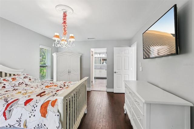 126 Holly Tree Ln, Brandon, FL 33511 - bedroom with multiple windows, a chandelier, dark wood finished floors, and connected bathroom