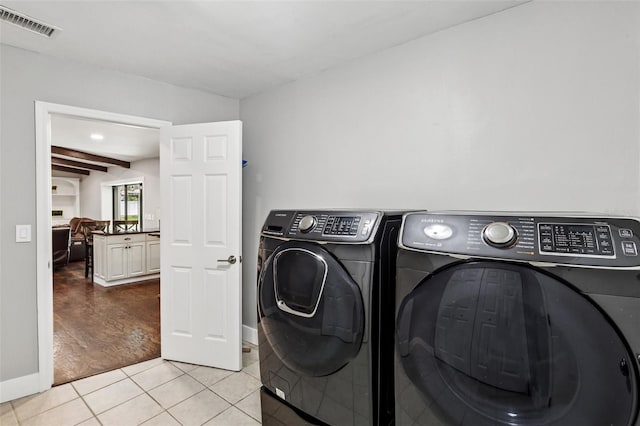 126 Holly Tree Ln, Brandon, FL 33511 - washroom featuring washing machine and dryer and light tile patterned flooring