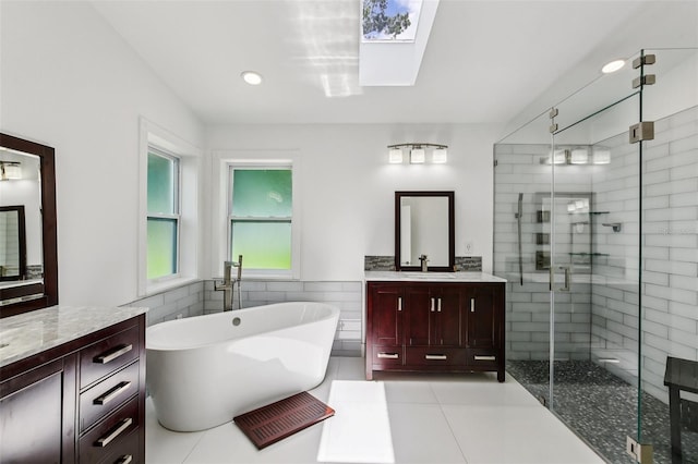 126 Holly Tree Ln, Brandon, FL 33511 - bathroom with a shower stall, vanity, a skylight, a soaking tub, and tile walls