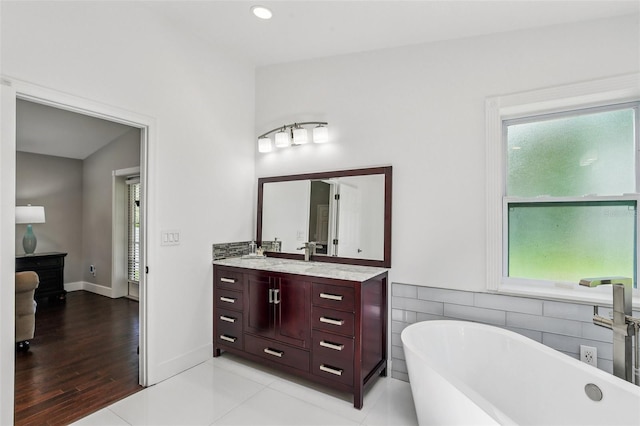 126 Holly Tree Ln, Brandon, FL 33511 - bathroom featuring a soaking tub, vanity, and healthy amount of natural light