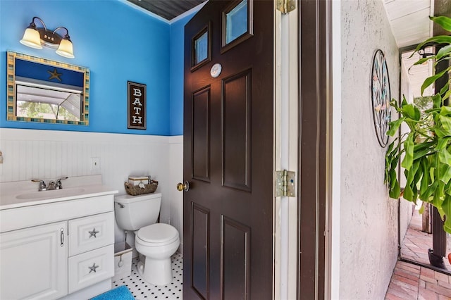 126 Holly Tree Ln, Brandon, FL 33511 - bathroom featuring a wainscoted wall, vanity, and brick floors
