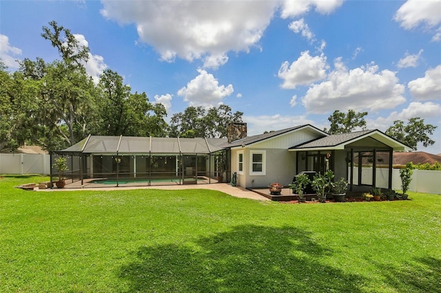 126 Holly Tree Ln, Brandon, FL 33511 - rear view of house with a fenced backyard, a patio, a chimney, and glass enclosure