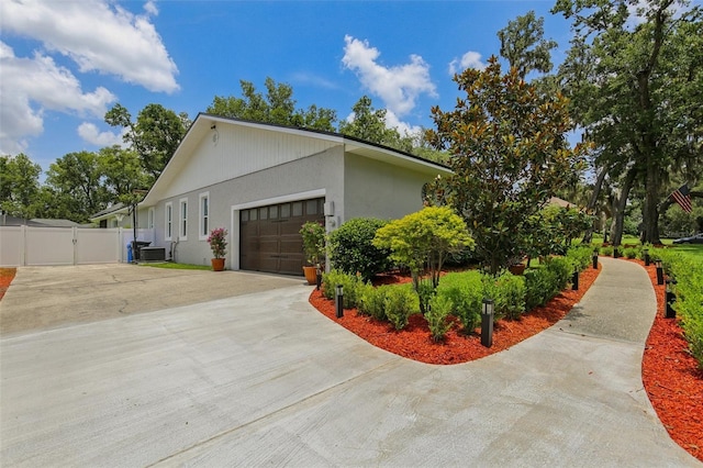 126 Holly Tree Ln, Brandon, FL 33511 - view of side of home featuring driveway, a garage, a gate, and stucco siding