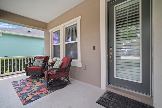 6408 Seasound Dr, Apollo Beach, FL 33572 - doorway to property with stucco siding and a porch