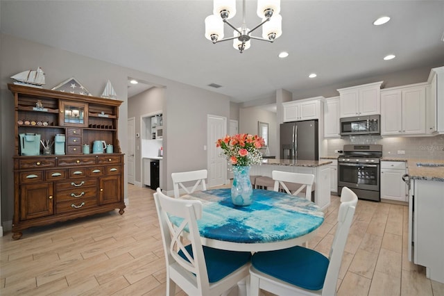 6408 Seasound Dr, Apollo Beach, FL 33572 - dining room featuring a chandelier, light wood-style floors, and recessed lighting