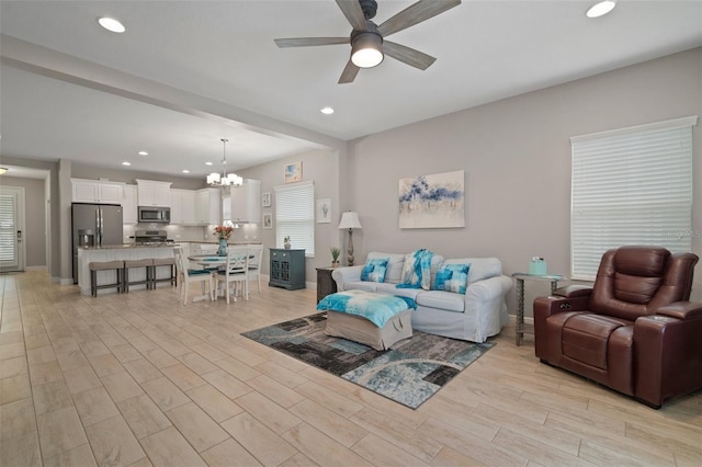 6408 Seasound Dr, Apollo Beach, FL 33572 - living area with a chandelier, ceiling fan, light wood-type flooring, and recessed lighting