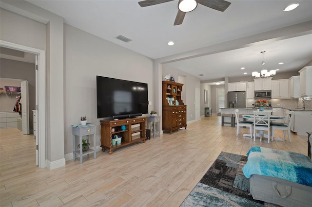 6408 Seasound Dr, Apollo Beach, FL 33572 - living room with light wood-type flooring, a chandelier, ceiling fan, and recessed lighting