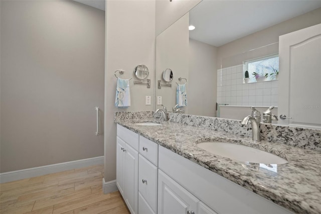6408 Seasound Dr, Apollo Beach, FL 33572 - full bathroom featuring double vanity and wood finished floors