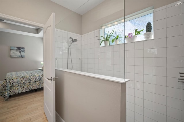 6408 Seasound Dr, Apollo Beach, FL 33572 - bathroom featuring walk in shower, wood finished floors, and connected bathroom