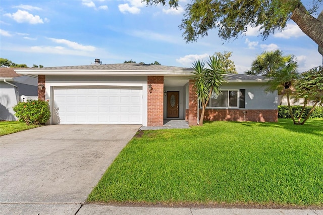 1667 E Orangeside Rd, Palm Harbor, FL 34683 - single story home featuring brick siding, a garage, concrete driveway, and a front yard