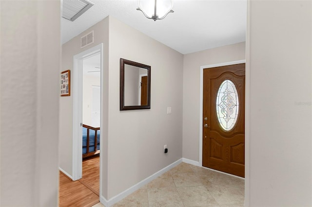 1667 E Orangeside Rd, Palm Harbor, FL 34683 - foyer with baseboards and light tile patterned flooring