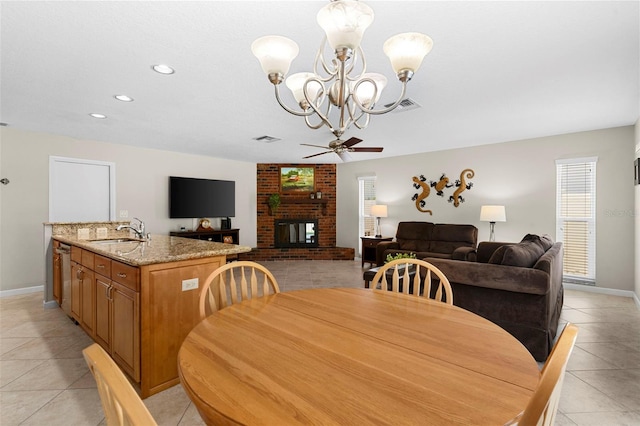 1667 E Orangeside Rd, Palm Harbor, FL 34683 - dining room featuring light tile patterned flooring, healthy amount of natural light, a chandelier, a brick fireplace, and recessed lighting