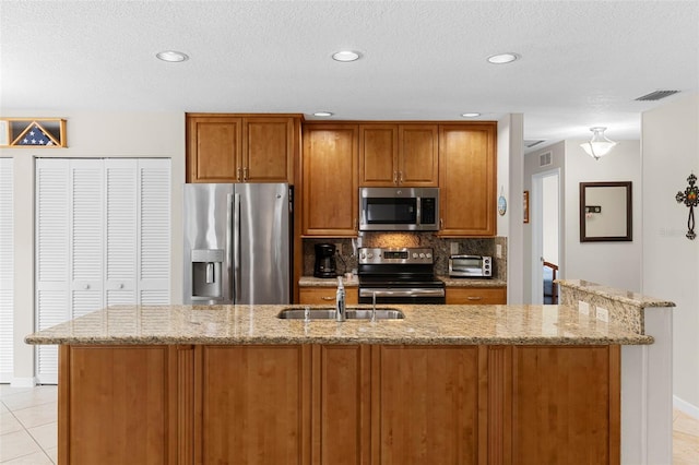1667 E Orangeside Rd, Palm Harbor, FL 34683 - kitchen with stainless steel appliances, brown cabinetry, light stone countertops, decorative backsplash, and recessed lighting