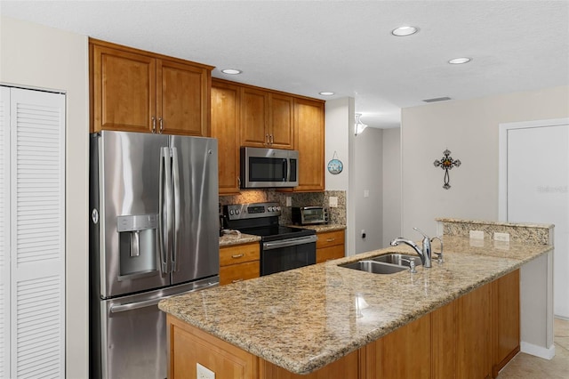 1667 E Orangeside Rd, Palm Harbor, FL 34683 - kitchen with appliances with stainless steel finishes, light stone counters, brown cabinetry, tasteful backsplash, and recessed lighting