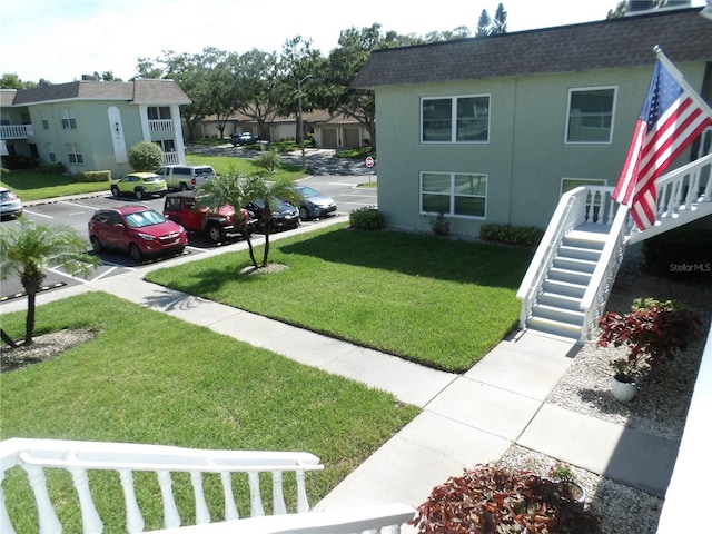 1250 S Pinellas Ave Unit 1013, Tarpon Springs, FL 34689 - view of grassy yard with stairs and a residential view