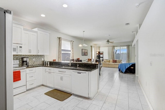 30247 Emmetts Ct, Wesley Chapel, FL 33543 - kitchen featuring white appliances, light marble finish flooring, ceiling fan, a peninsula, and open floor plan