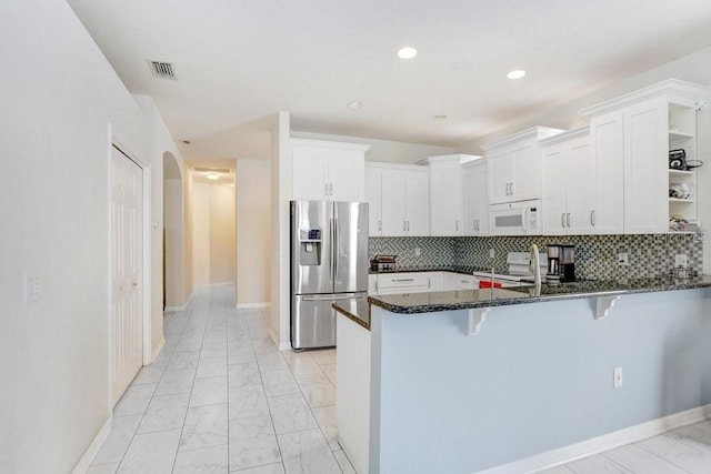 30247 Emmetts Ct, Wesley Chapel, FL 33543 - kitchen with white appliances, open shelves, light marble finish floors, a peninsula, and recessed lighting