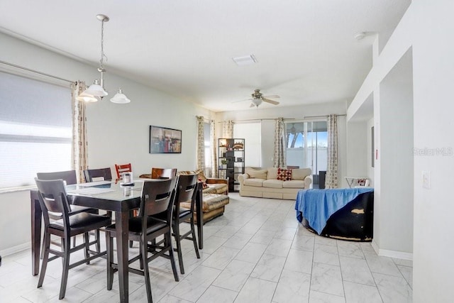 30247 Emmetts Ct, Wesley Chapel, FL 33543 - dining space featuring light marble finish flooring and a ceiling fan
