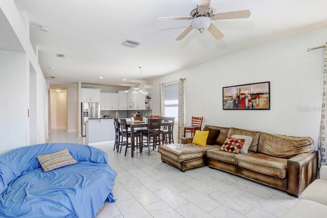 30247 Emmetts Ct, Wesley Chapel, FL 33543 - living area with ceiling fan and light marble finish flooring