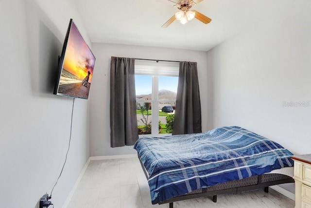30247 Emmetts Ct, Wesley Chapel, FL 33543 - bedroom featuring light marble finish floors and a ceiling fan
