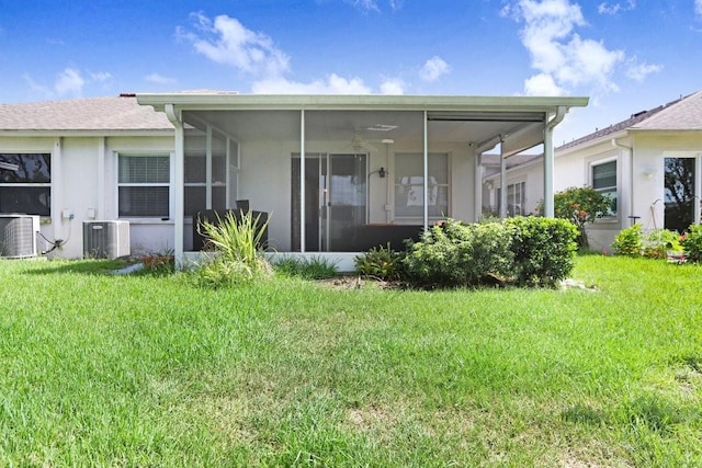 30247 Emmetts Ct, Wesley Chapel, FL 33543 - back of property featuring a sunroom, a lawn, and stucco siding