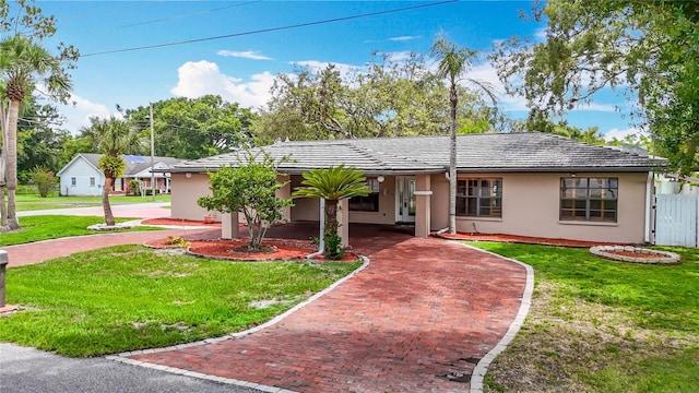 4002 Hudson Ter, Tampa, FL 33618 - single story home with decorative driveway, stucco siding, and a front yard