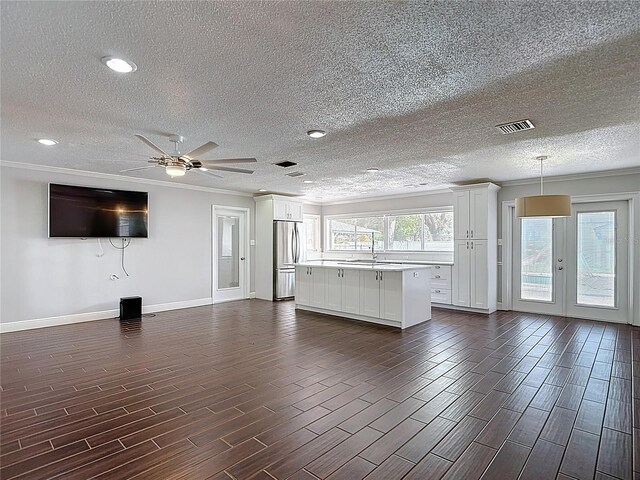4002 Hudson Ter, Tampa, FL 33618 - unfurnished living room featuring a textured ceiling, crown molding, french doors, dark wood-style flooring, and ceiling fan