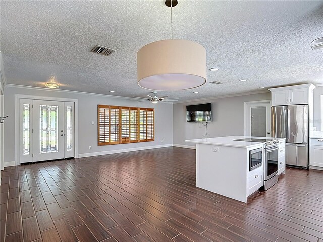 4002 Hudson Ter, Tampa, FL 33618 - kitchen with appliances with stainless steel finishes, a ceiling fan, a textured ceiling, crown molding, and light countertops