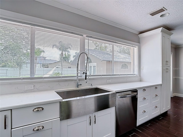 4002 Hudson Ter, Tampa, FL 33618 - kitchen with stainless steel dishwasher, dark wood-style flooring, ornamental molding, a textured ceiling, and light countertops