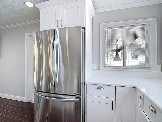 4002 Hudson Ter, Tampa, FL 33618 - kitchen featuring freestanding refrigerator, crown molding, a textured ceiling, dark wood finished floors, and white cabinetry