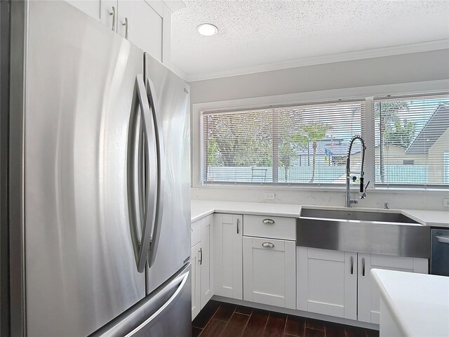 4002 Hudson Ter, Tampa, FL 33618 - kitchen featuring freestanding refrigerator, a textured ceiling, dark wood finished floors, crown molding, and light countertops