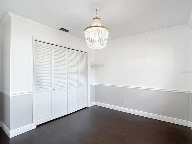 4002 Hudson Ter, Tampa, FL 33618 - unfurnished dining area featuring dark wood-type flooring, a chandelier, and ornamental molding