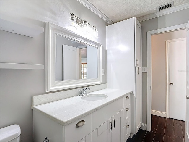 4002 Hudson Ter, Tampa, FL 33618 - bathroom featuring vanity, ornamental molding, wood finished floors, and a textured ceiling