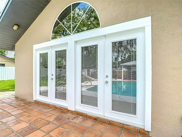 4002 Hudson Ter, Tampa, FL 33618 - entryway featuring french doors, a textured wall, and vaulted ceiling