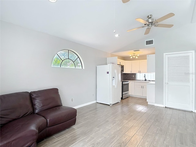 4002 Hudson Ter, Tampa, FL 33618 - living area with light wood finished floors, ceiling fan, vaulted ceiling, and recessed lighting