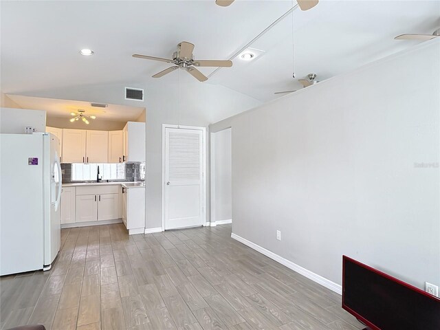 4002 Hudson Ter, Tampa, FL 33618 - unfurnished living room with a ceiling fan, lofted ceiling, and light wood finished floors