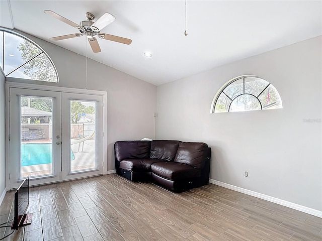 4002 Hudson Ter, Tampa, FL 33618 - living area featuring light wood finished floors, french doors, vaulted ceiling, ceiling fan, and recessed lighting