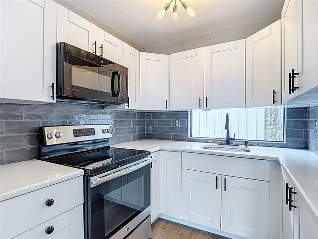 4002 Hudson Ter, Tampa, FL 33618 - kitchen featuring stainless steel range with electric cooktop, black microwave, light countertops, and tasteful backsplash