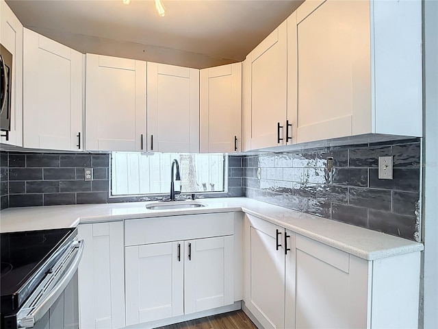 4002 Hudson Ter, Tampa, FL 33618 - kitchen featuring tasteful backsplash, light countertops, stainless steel appliances, and white cabinets