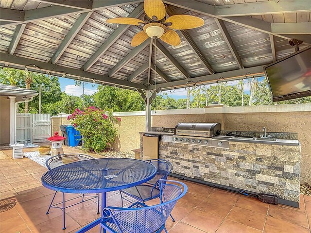 4002 Hudson Ter, Tampa, FL 33618 - view of patio / terrace featuring area for grilling, ceiling fan, a gate, outdoor dining space, and a gazebo