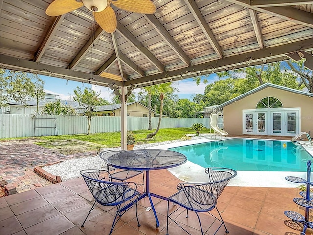 4002 Hudson Ter, Tampa, FL 33618 - view of pool featuring a water slide, french doors, ceiling fan, a fenced backyard, and an outdoor structure