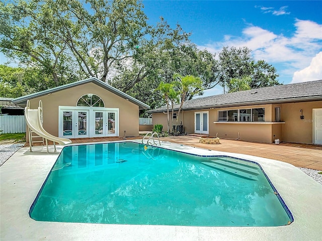 4002 Hudson Ter, Tampa, FL 33618 - view of swimming pool featuring french doors, a water slide, a storage structure, and a patio