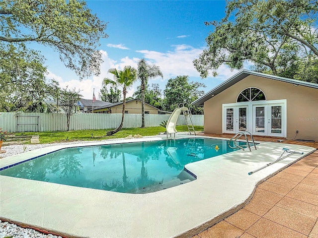 4002 Hudson Ter, Tampa, FL 33618 - view of pool featuring french doors, a water slide, a fenced backyard, and a patio area