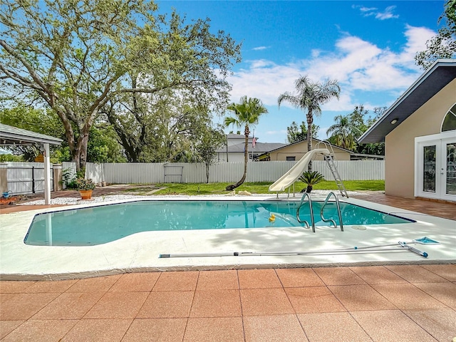 4002 Hudson Ter, Tampa, FL 33618 - view of pool featuring a patio, a water slide, a fenced backyard, and french doors